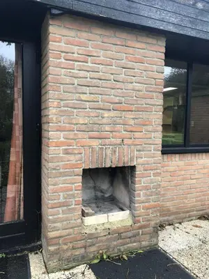 a brick oven in the side of a building at Bungalow in Sonnevijver - Hoge kempen in Lanaken