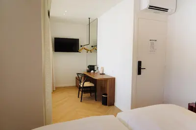 a bedroom with a desk and a bed and a table at Door9 Hasselt - Digital Hotel & Restaurant in Hasselt