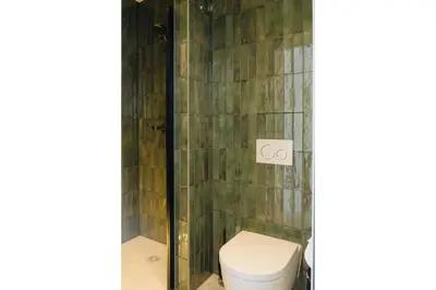 a bathroom with a toilet and a shower at Door9 Hasselt - Digital Hotel & Restaurant in Hasselt