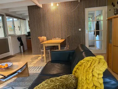 a living room with a leather couch and a table at heerlijk vakantie huis Lovely holiday home in Lanaken