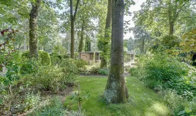 a house in the middle of a forest at heerlijk vakantie huis Lovely holiday home in Lanaken