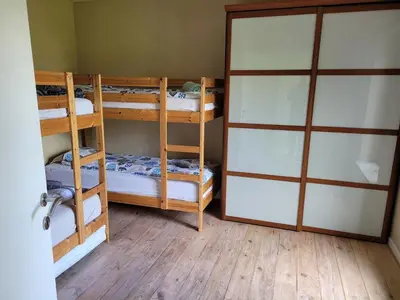 a room with two bunk beds and a sliding door at Casa Loon in Borgloon
