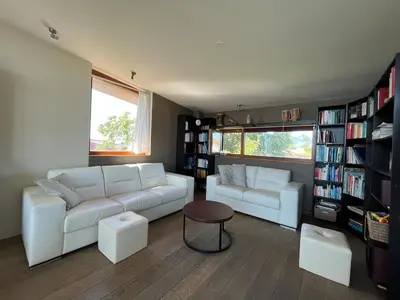 a living room with two white couches and a table at Casa Loon in Borgloon