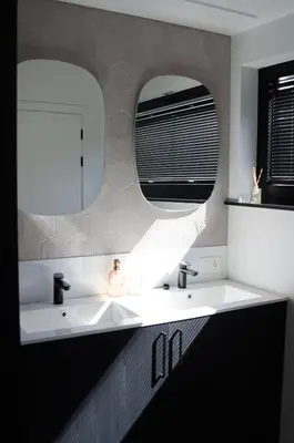 a bathroom with a white sink and two mirrors at Vakantiewoning Ten Huyze Bucholt met tuinsauna in Bocholt