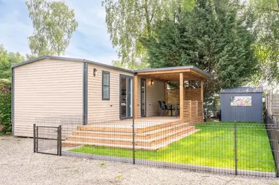 a tiny house with a porch and a deck at Family chalet Kinrooi - Papillon Kinrooi in Kinrooi