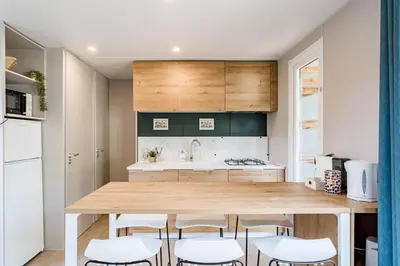 a kitchen with a large wooden table and chairs at Family chalet Kinrooi - Papillon Kinrooi in Kinrooi