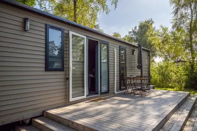 a screened porch of a house with a deck at Family chalet Kinrooi - Papillon Kinrooi in Kinrooi