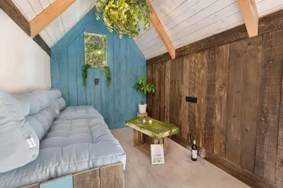 a living room with a couch and a table at Mirabel - DreamsCanGrow in Hasselt