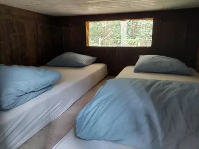 two beds in a small room with a window at Mirabel - DreamsCanGrow in Hasselt