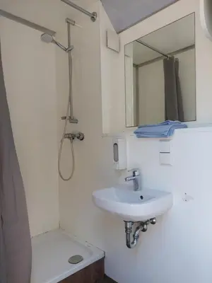 a white bathroom with a sink and a mirror at Mirabel - DreamsCanGrow in Hasselt