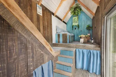 a room with wooden walls and a staircase in a house at Mirabel - DreamsCanGrow in Hasselt