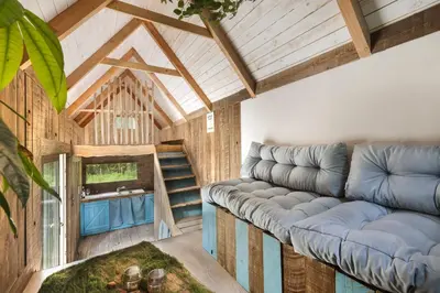a living room with a couch and a table at Mirabel - DreamsCanGrow in Hasselt