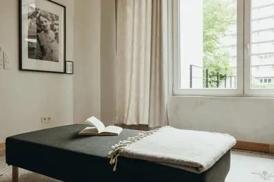 a bedroom with a bed with a book on it at Beauvoir, Parc de la Boverie by WelcHome in Liège