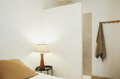 a bedroom with a bed and a lamp and a shower at Beauvoir, Parc de la Boverie by WelcHome in Liège