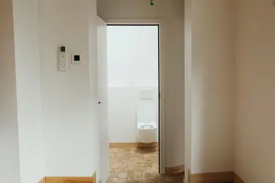 a bathroom with a white toilet in a room at Champagne, Parc de la Boverie by WelcHome in Liège