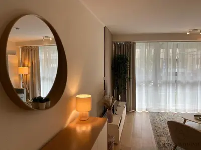 a living room with a mirror and a table at Open Design apartment in Liège