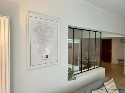 a picture on the wall of a living room at Open Design apartment in Liège