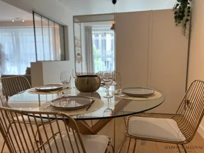 a dining room table with glasses and plates on it at Open Design apartment in Liège