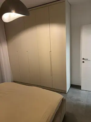 a bedroom with a bed and a large closet at Heel Appartement 90m2 met 2 slaapkamers woonkamer Keuken badkamer privé garage in Sint-Truiden