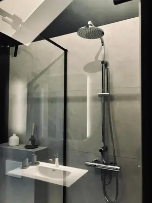 a bathroom with a shower and a sink at Crossborder Nest - Appartement de standing proche du circuit SPA-FRANCORCHAMPS et des HAUTES-FAGNES in Verviers