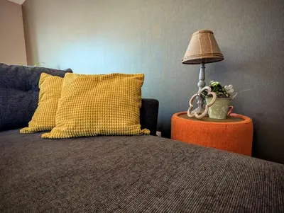 a lamp on a table next to a bed at Landbæne in Lommel