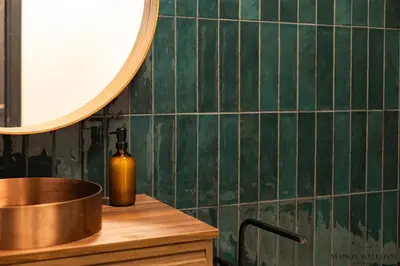 a bottle of oil sitting on a counter in a kitchen at Le cocon chic - Hypercentre, Place du Marché in Liège