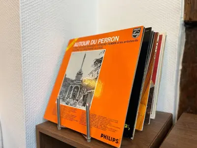 an orange book sitting on top of a shelf at Le cocon chic - Hypercentre, Place du Marché in Liège