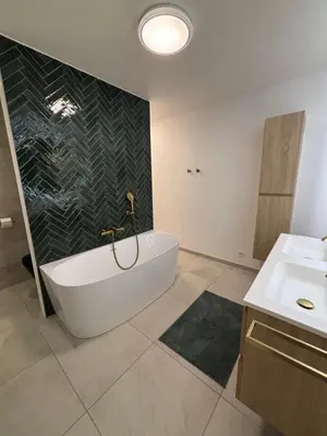 a bathroom with a bath tub and a sink at Home Terboekt in Genk
