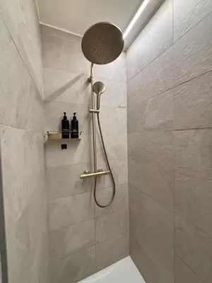 a shower with a shower head in a bathroom at Home Terboekt in Genk