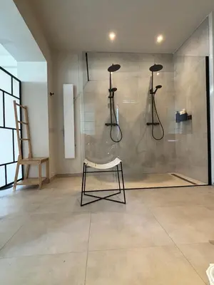 a room with a shower with a chair in it at Les Tours de Rose - Characterful accommodation in Waremme in Waremme