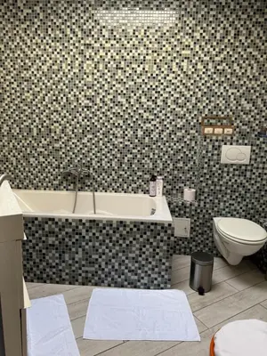 a bathroom with a bath tub and a toilet at Bel appart - Tilff in Tilff