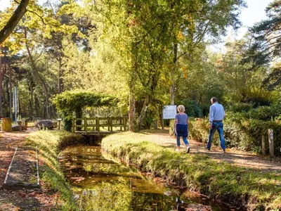a man and a woman walking along a canal at Ibiza LOFT MOLN in Kinrooi
