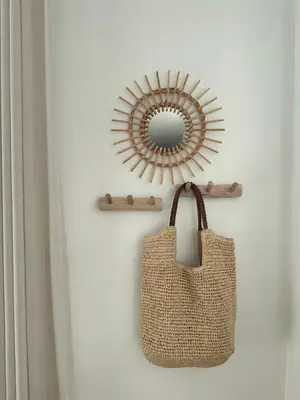 a mirror and a tote bag on a wall at Ibiza LOFT MOLN in Kinrooi