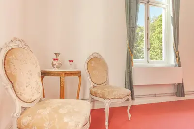 two chairs and a table in a room with a window at 12P 6B Renovated villa with jacuzzi at Genk in Genk