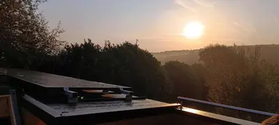 a view of the sunset from a roof of a house at Tiny House Dreiländereck in Neu-Moresnet