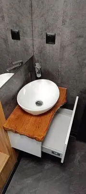 a white sink on a wooden counter in a bathroom at Tiny House Dreiländereck in Neu-Moresnet