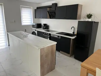 a kitchen with a black refrigerator and a counter at DEDIA Guest Home