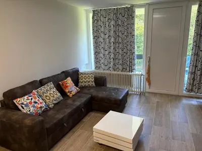 a living room with a leather couch and a coffee table at Appart de Lux , 3 borders , free parking , in La Calamine