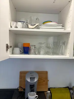a cupboard with dishes and other items on it at Appart de Lux , 3 borders , free parking , in La Calamine
