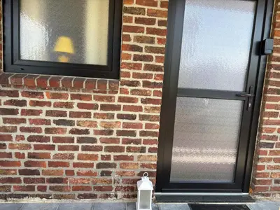 a brick wall with a window with a lamp in it at Appart de Lux , 3 borders , free parking , in La Calamine