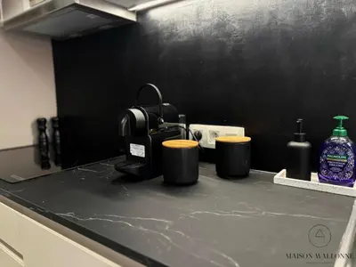 a kitchen counter with two cups on top of it at Le 180 escapade face à la Meuse in Liège