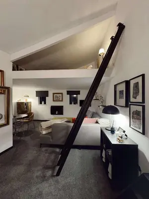 a bedroom with a bed and a staircase in it at Felicita in Jalhay