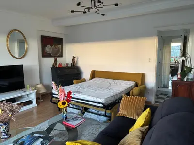 a living room with a bed and a couch at Central peak of Embourg Apartment in Chaudfontaine