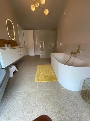 a bathroom with a large white tub in a room at Cièlo in Tongeren