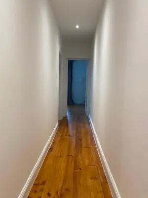an empty hallway with white walls and a wooden floor at Cièlo in Tongeren