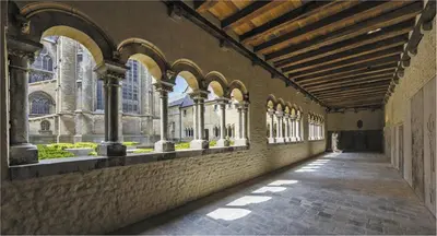 an empty hallway of a building with arches and windows at Cièlo in Tongeren