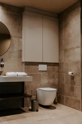a bathroom with a toilet and a sink at Hangar C gastensuites in Heers