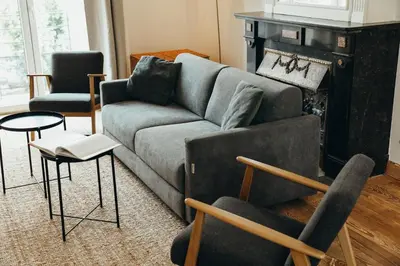 a living room with a couch and chairs and a fireplace at Simonis, Parc de la Boverie by WelcHome in Liège