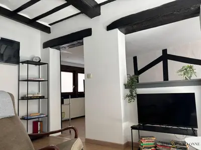 a living room with a large flat screen tv on a wall at Petite maison typique en Outremeuse - 2 à 4 personnes in Liège
