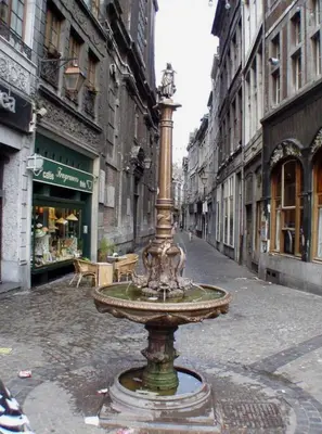 a fountain in the middle of a city street at AppartCosy in Liège